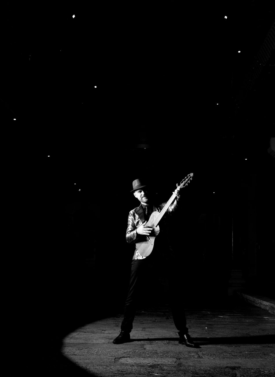 Luis Coelho on stage with nylon-string guitar