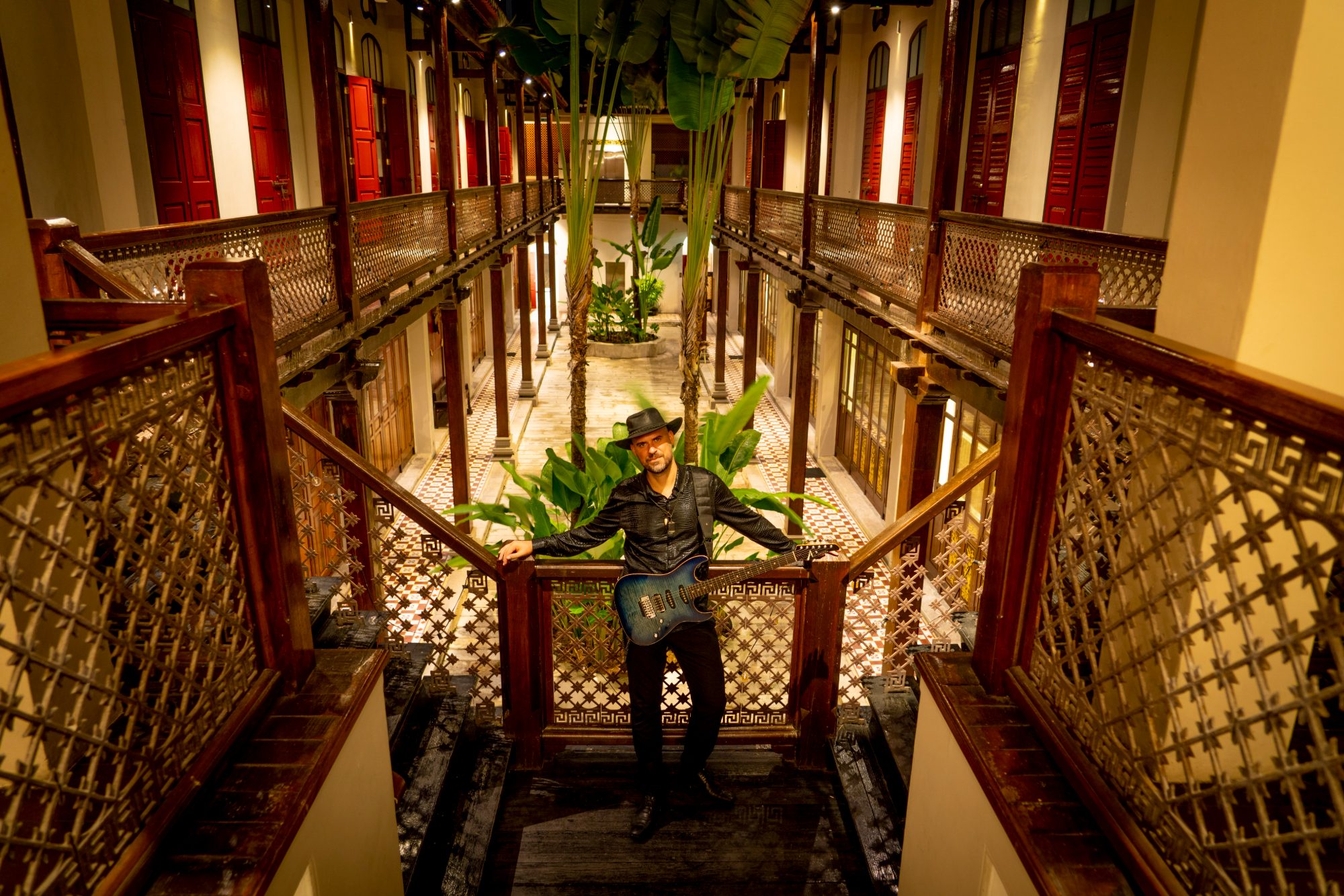 Luis Coelho on the staircase with guitar